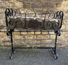 A cast metal scroll design garden planter complete with liner. 64cm l x 65cm h x 24cm d.