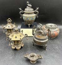 A collection of five Oriental incense burners, three bronze to include two raised on three elongated