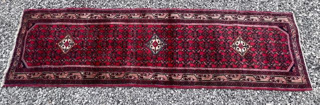 A good quality red Persian Hussainabad wool runner. 287 x 80cm.