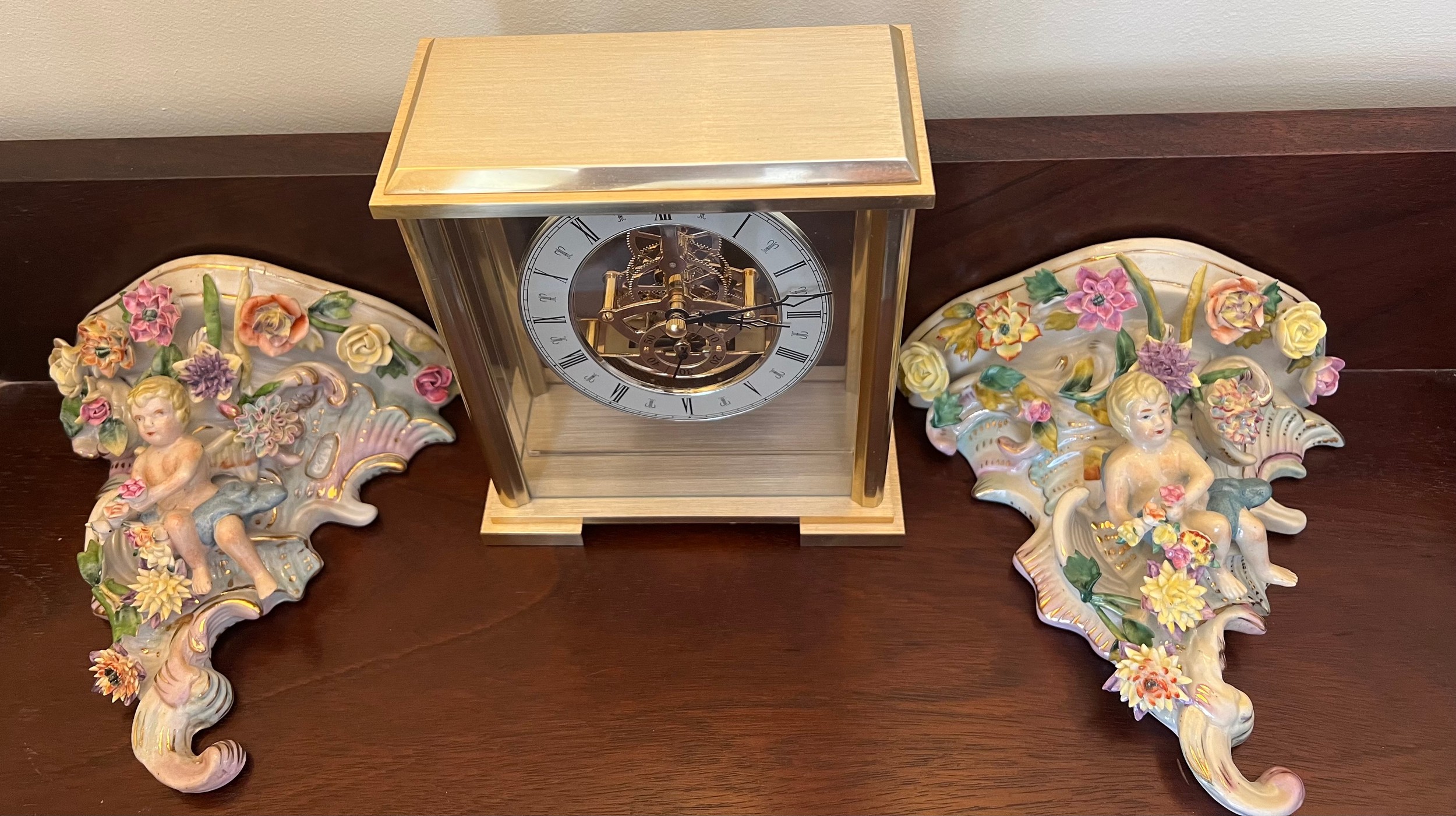 A modern gilt cased mantle clock together with two continental porcelain wall brackets with putti - Image 2 of 4