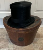 A 19thC leather top hat box and hat. 25cm h.