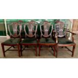 Eight mahogany shield back chairs to include two carvers, all with drop in seats.