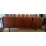 A teak sideboard by Axel Christensen for Aco Møbler, Danish, mid century. Four sliding doors to