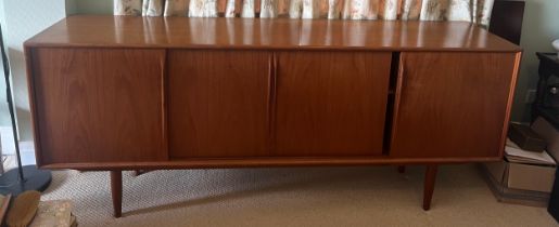 A teak sideboard by Axel Christensen for Aco Møbler, Danish, mid century. Four sliding doors to