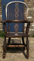 A 19thC broad armed Windsor chair with double H stretcher measuring approx 116cm h floor to top of