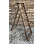 A pair of vintage pine folding stepladders. 124cm h x 44cm w at base.
