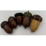 Five wooden (treen) acorn thimble holders and thimbles. Three hallmarked silver thimbles including