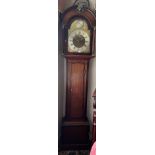 An oak longcase clock by Michael Wilde Wakefield with 8 day movement and brass face. Door with ivory