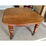 Mahogany wind out table with two extra leaves, with porcelain castors and winder closed 136cm long x