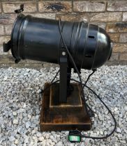 A black vintage theatre lamp mounted on a wooden base. Approx 55cm h.