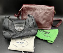 Genuine Prada handbag in vintage black leather together with an Emmy burgundy soft leather crossbody