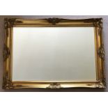 Large gilt bevelled edged mirror measuring 77cm h x 107cm w.