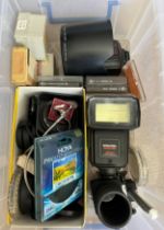 A box of vintage camera accessories to include lens caps, filters, flash lights etc.