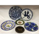 A collection of six ceramic plates from various makers to include two blue and white plates signed