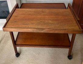 A metamorphic rosewood tea trolley. With top extended measures 76cm x 71cm x 68cm h.