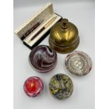 A miscellany comprising a vintage brass shop bell, 4 glass paperweights to include Uredale, boxed