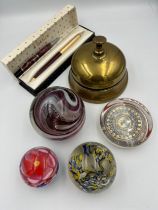 A miscellany comprising a vintage brass shop bell, 4 glass paperweights to include Uredale, boxed