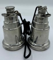 A novelty pewter hip flask modelled as a pair of binoculars, each eye piece unscrewing to form two