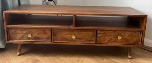 A modern coffee table with three drawers. 125cm l x 39cm w x 44cm h.