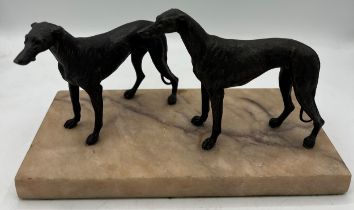 Unsigned bronze sculpture depicting two hound dogs on a marble base. 14cm h.