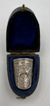 A leather cased silver thimble in the shape of a fingernail. London 1905, maker SF pat. 19157