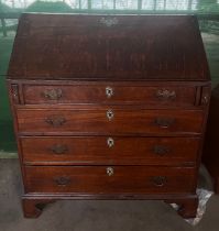 A 19thC oak bureau with four graduated drawers and bracket feet with fitted interior. 92cm x 108cm x