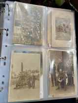 An album containing multiple postcards including WW1 and WW1 silk postcards, funeral notices etc.