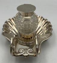 Silver shell shaped ink stand/pen rest. Stand Chester 1898, maker Stokes and Ireland, inkwell