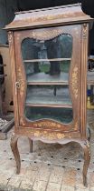 A French style mahogany inlaid display cabinet on cabriole legs with gilt metal mounts and gilt meta