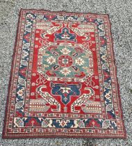 A large Caucasian rug, red, blue and cream ground. 199 x 281cm.