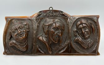 An Arts and Crafts copper relief moulded plaque, 'Y'e Jesters' depicting three jesters 'Very Funny',