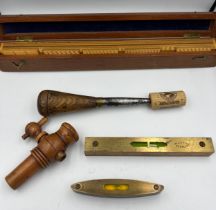 Two small wooden cased spirit levels, a boxwood spigot, a treen, brass and metal fid and a boxed set