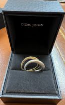 Two Georg Jensen rings from the Offspring collection, one 18 carat gold 4.2gm and one silver.
