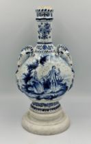 A late 19th/early 20thC Dutch blue and white faience olive oil jar, 35cm h. together with a marble