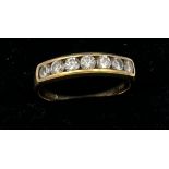 An 18 carat yellow gold ring set with 7 diamonds. Size I/J. Weight 1.7gm.