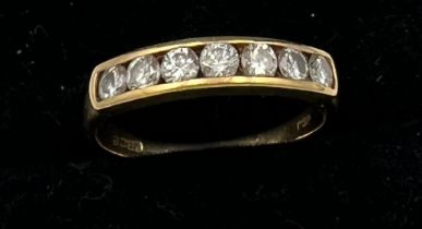 An 18 carat yellow gold ring set with 7 diamonds. Size I/J. Weight 1.7gm.