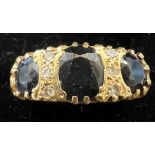 A sapphire and diamond ring set in 18 carat yellow gold. Size L, weight 6.7gm.