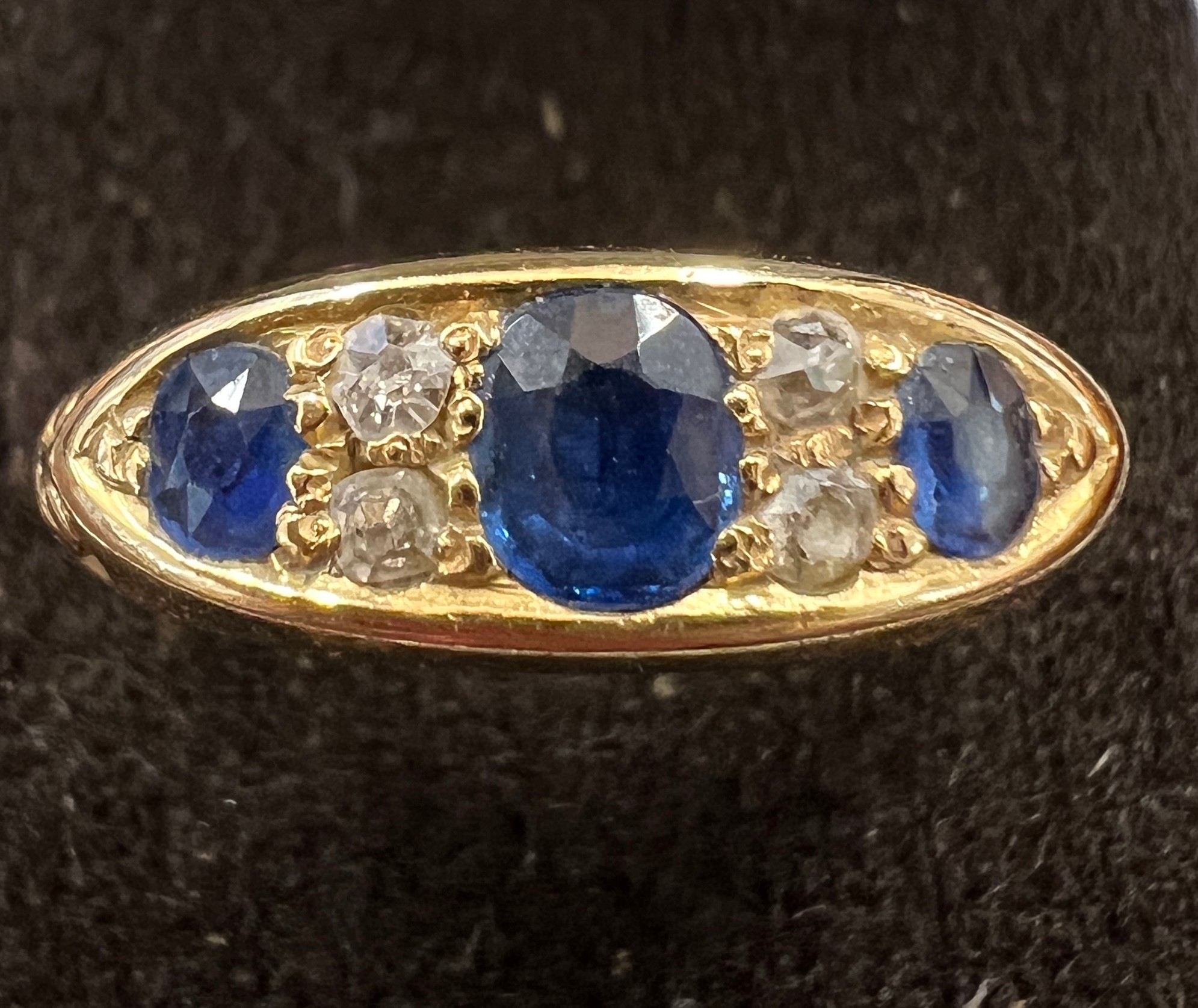 An 18 carat sapphire and diamond ring. Size P. Weight 4gm.