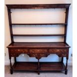 An 18thC oak dresser and rack with original iron hooks, 165 w x 195 h x 41cm d.