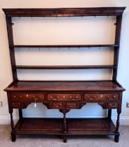 An 18thC oak dresser and rack with original iron hooks, 165 w x 195 h x 41cm d.