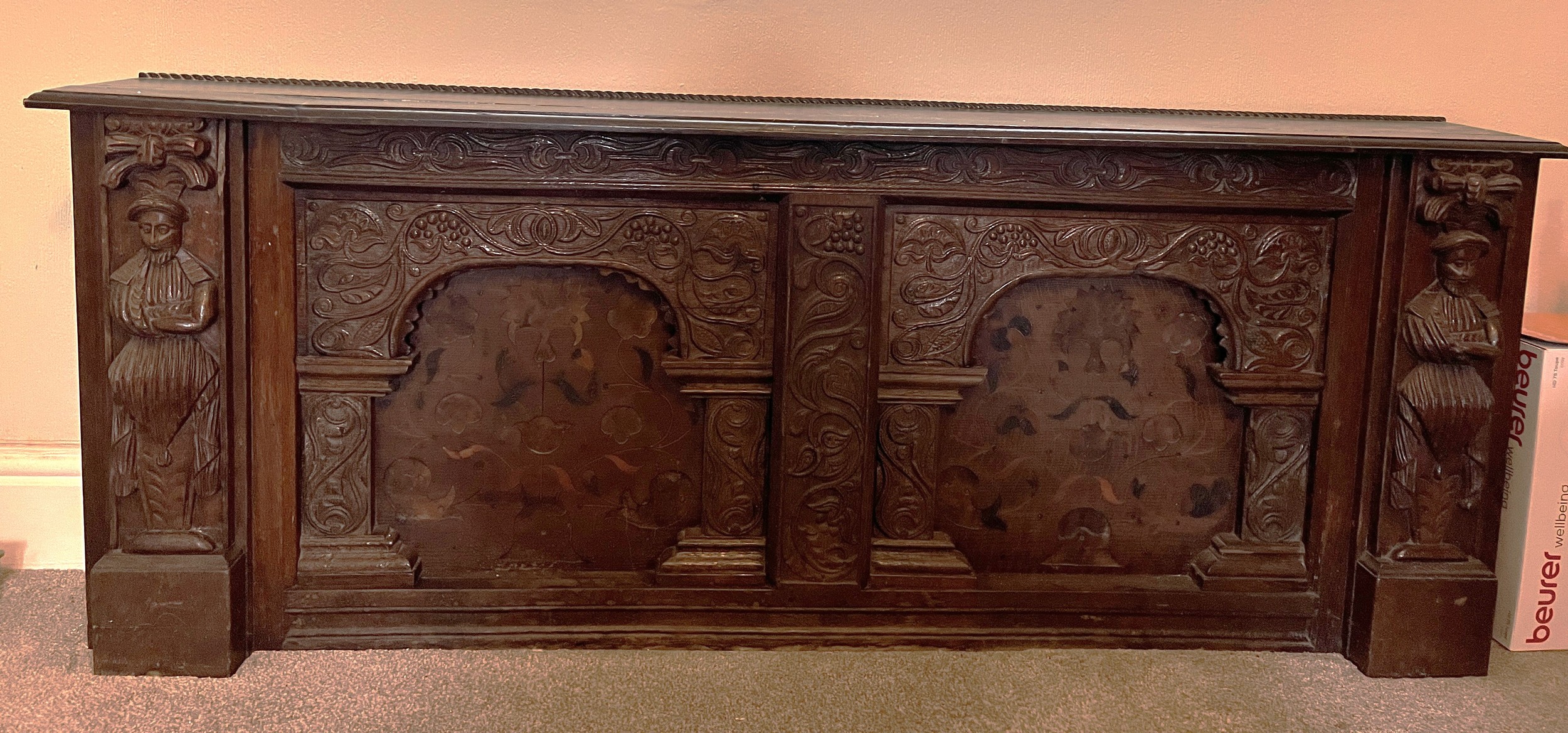 Part of an oak over mantle with carving and marquetry. Originally from Ravine House in Filey, now