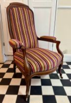 A French mahogany high back armchair with upholstered seat, back and arms, front cabriole legs and