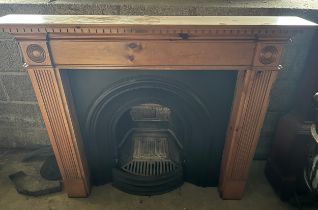 A cast iron fireplace insert with pine surround. 138cm w x 20.5cm d x 110cm h.