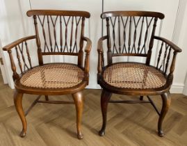 Two cane seated armchairs.