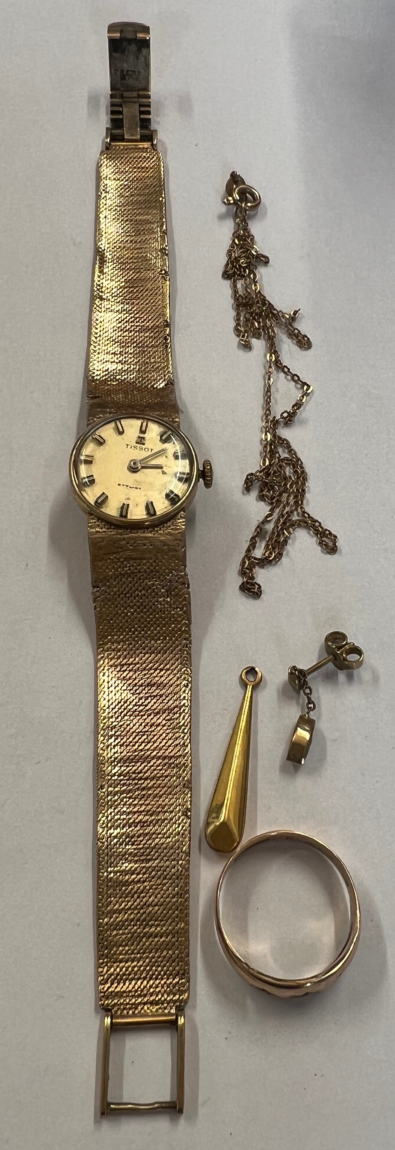 Nine carat gold Tissot watch and strap, gem set ring and unmarked chain and two odd earrings.
