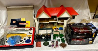 A miscellany of toys and games: a vintage Triang dolls house and various contents to include three