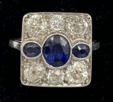 A diamond and sapphire square shaped ring set in platinum. Six old cut diamonds 4 x 0.25 carat, 2