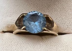 A 9 carat gold ring set with blue stone. Size I/J. Weight 3.7gm.