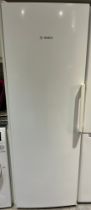A Bosch high fridge with single door. 59cm w x 176cm h.