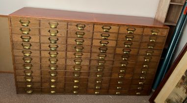 A vintage oak filing cabinet with brass fittings. 149cm w x 38cm d x 86cm h.